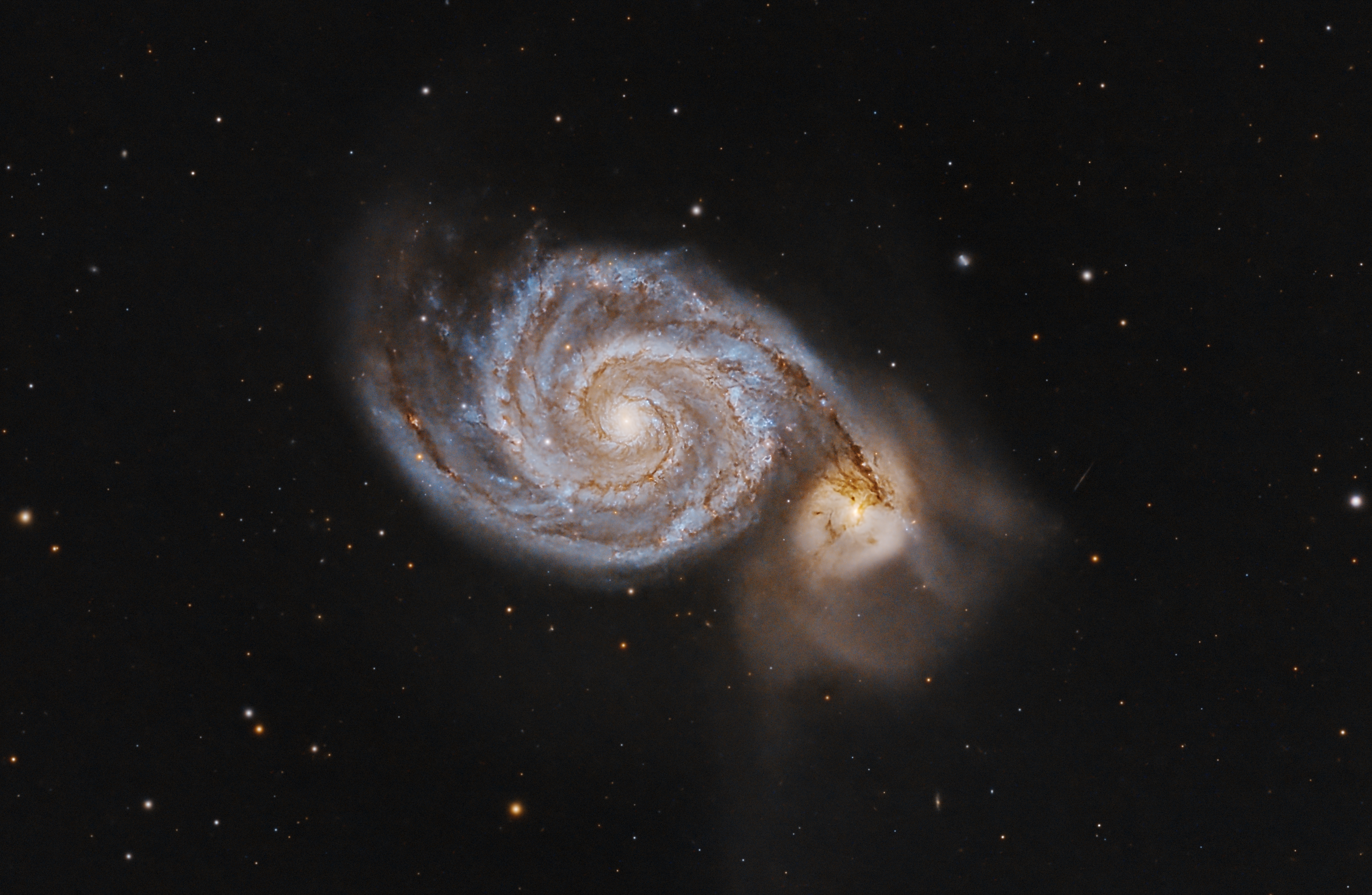Astronomy photograph of two interacting spiral galaxies in a star field
