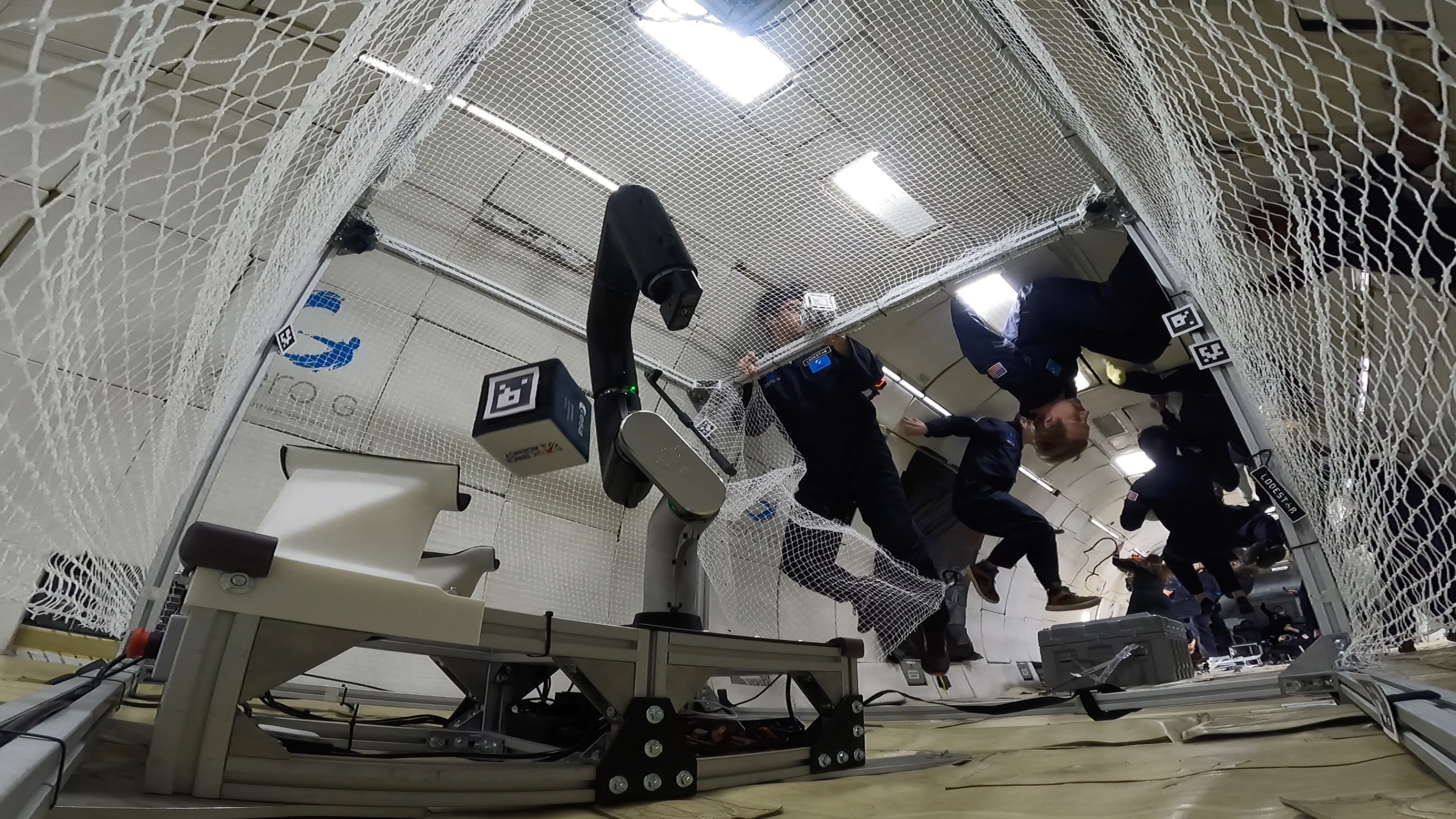 Robotic arm tracking a (soft) cube in low gravity.