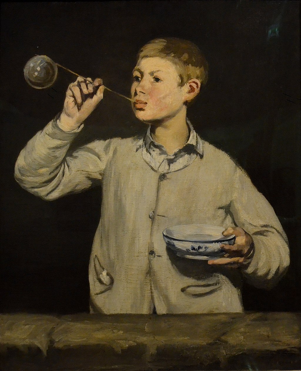 Manet painting of a young boy blowing a soap bubble