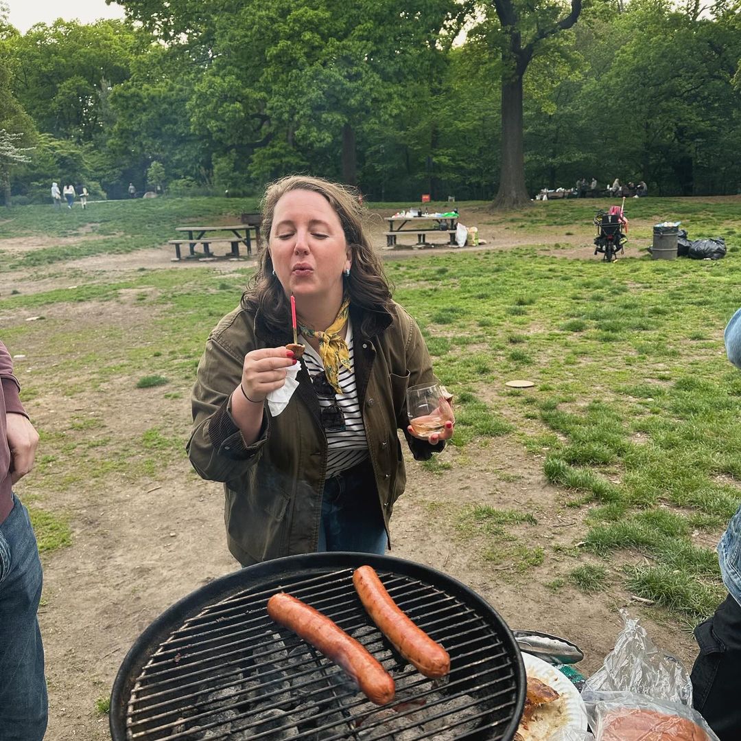 Brianna by a BBQ of sausages. Brianna by a BBQ of sausages.