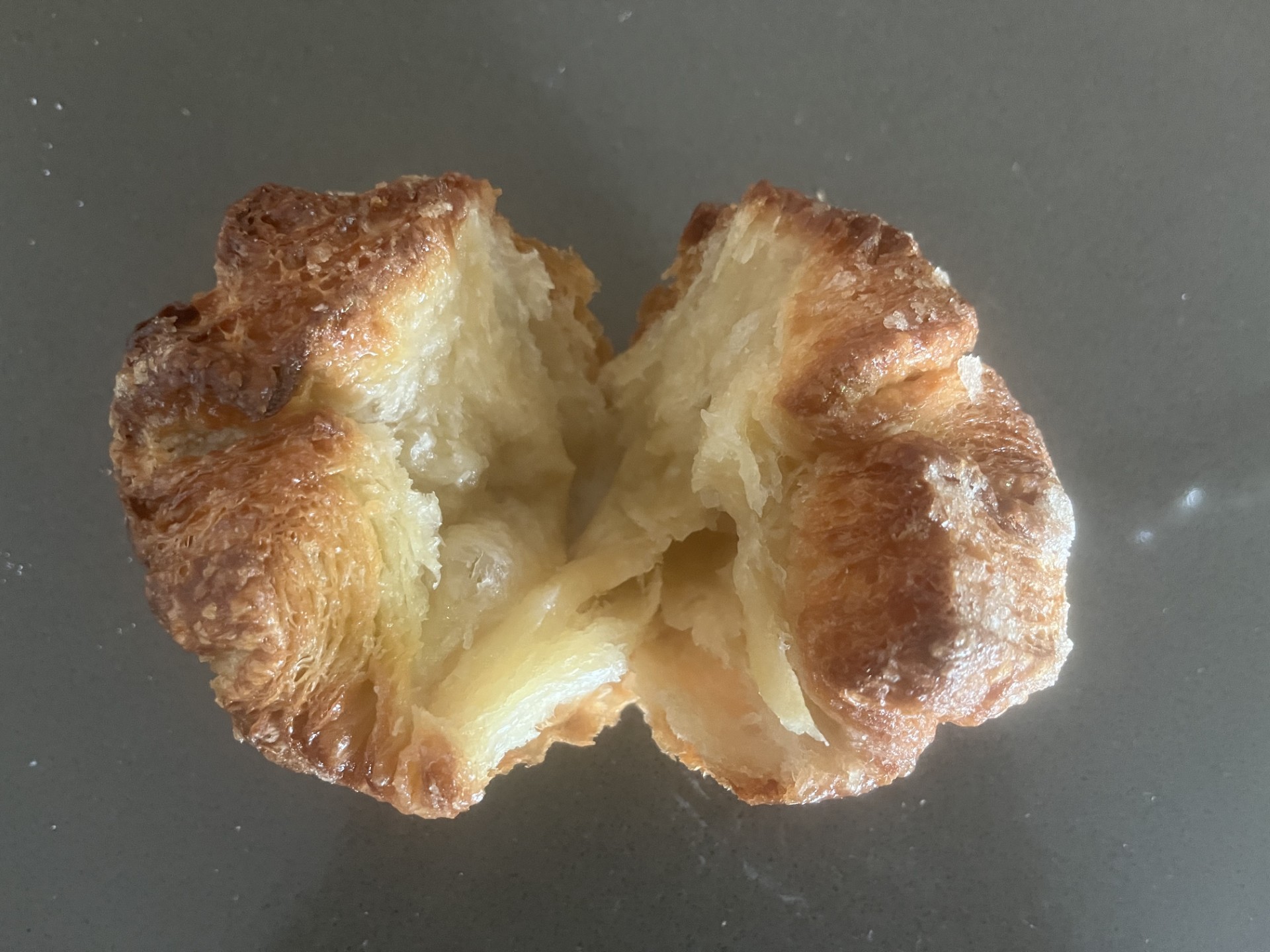 Kouign-amann cut open to show its layered buttery interior