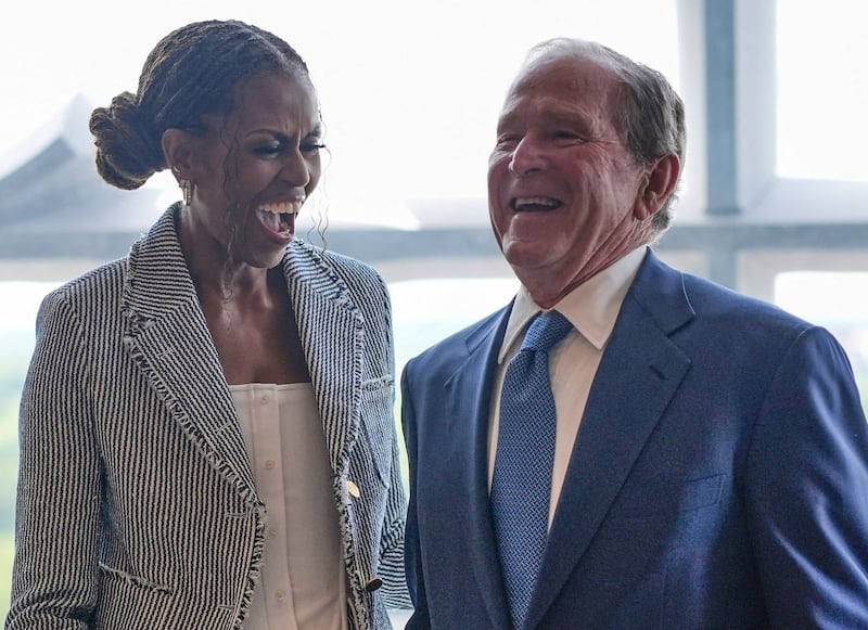 Former president George W. Bush laughs with former first lady Michelle Obama ahead of the dedication ceremony at the Obama Presidential Center, in Chicago, Illinois, U.S., June 18, 2026. Pablo Martinez Monsivais/Pool via REUTERS