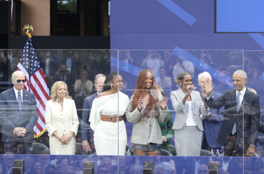 Former President Joe Biden, former first lady Jill Biden, Sasha and Malia Obama, former first lady Michelle Obama and former President Barack Obama smile.