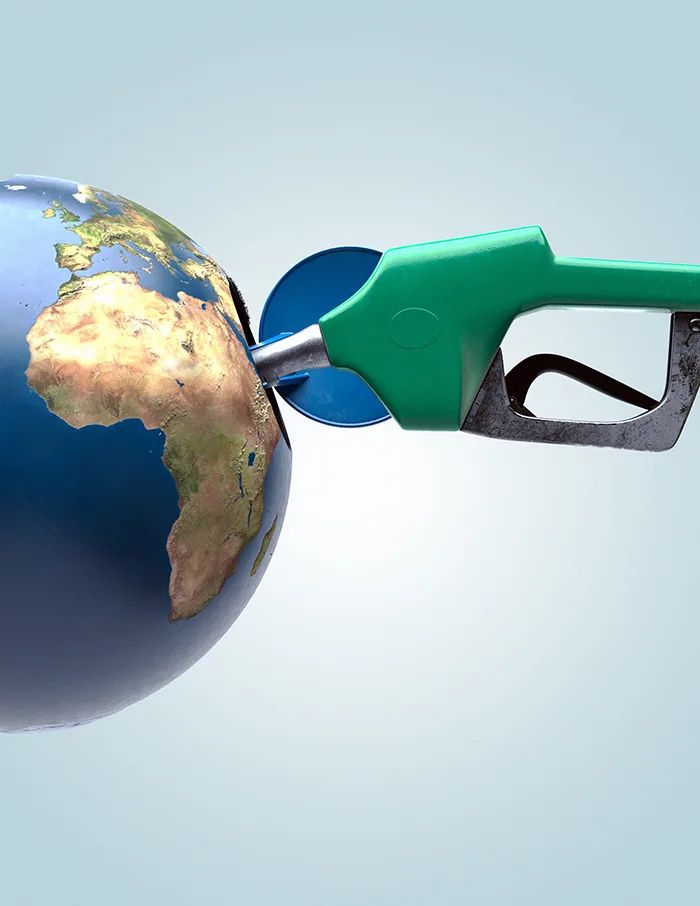 This may contain: a pair of green and black gas pumps with the earth on it's side