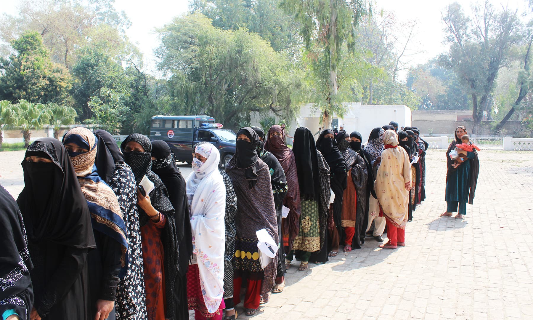 Women form queues to get a CNIC from Nadra's mobile registration van in Kalabagh. — Photo by author