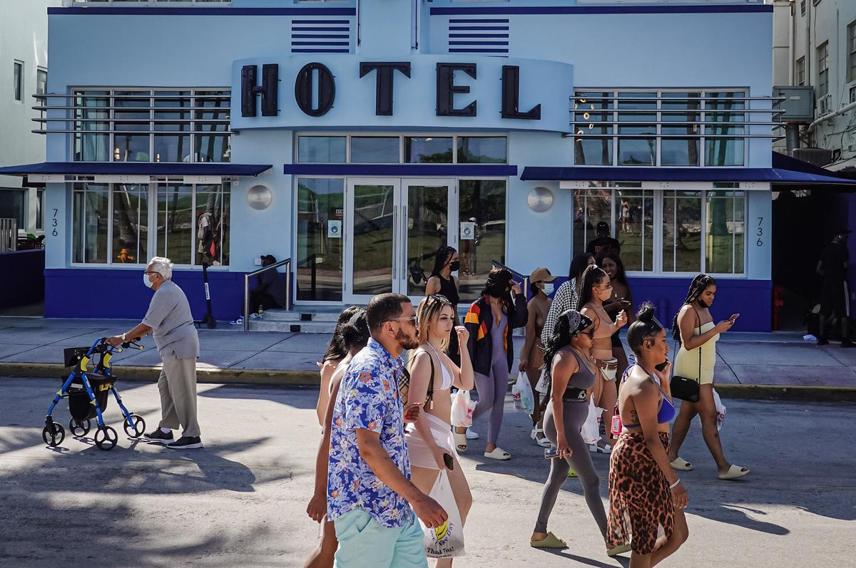 People walk along Ocean Drive during spring break in Miami Beach, Fla., on March 16, 2021. (Joe Raedle/Getty Images) People walk along Ocean Drive during spring break in Miami Beach, Fla., on March 16, 2021. (Joe Raedle/Getty Images)