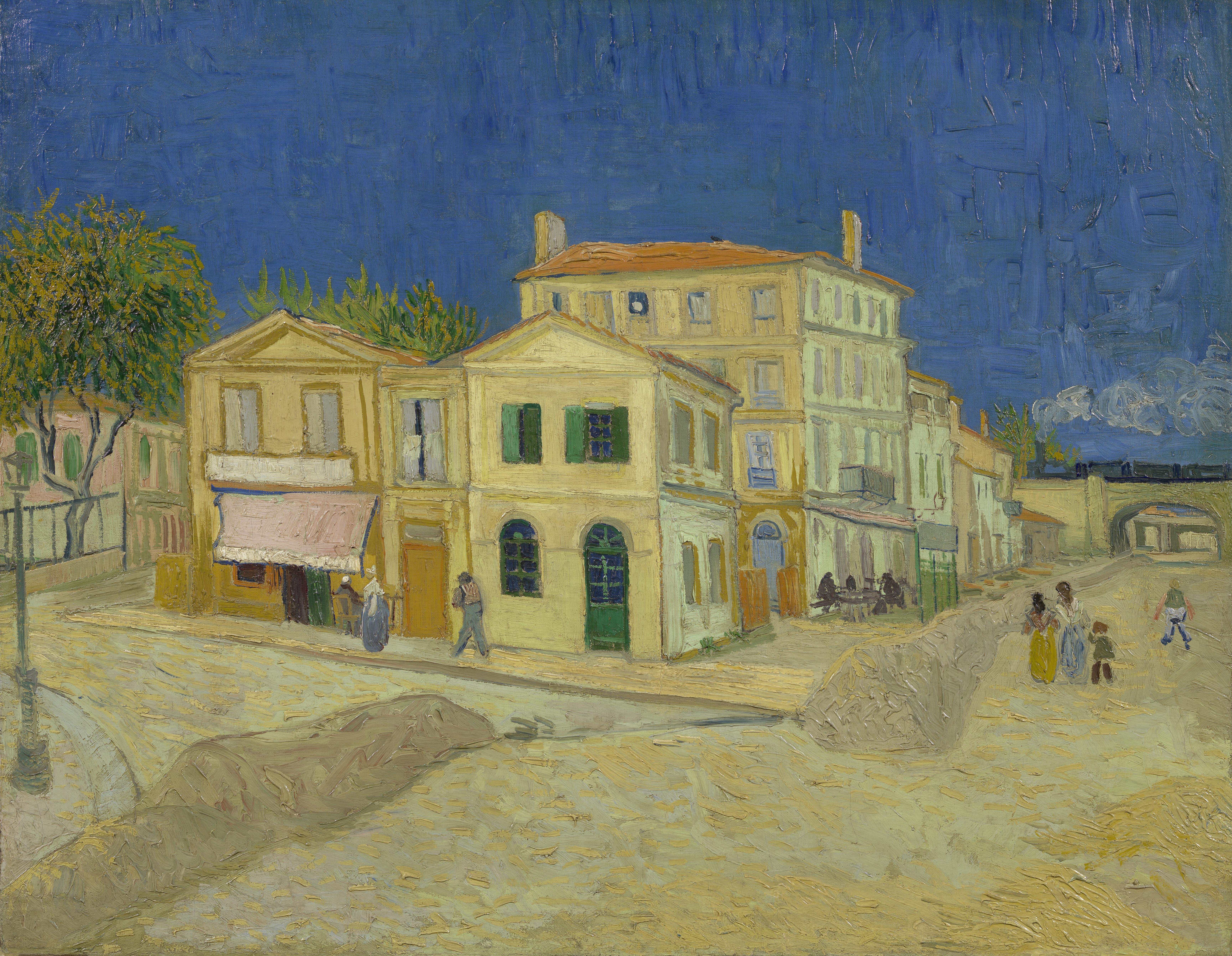 Van Gogh's painting of the Yellow House in Arles beside a road under a blue sky