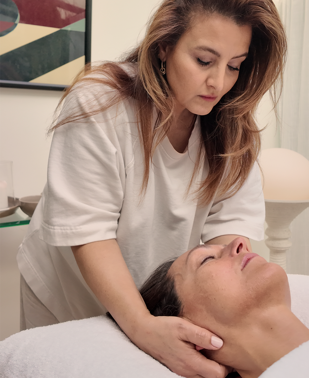 Najat giving a holistic facial and holding space in the salon