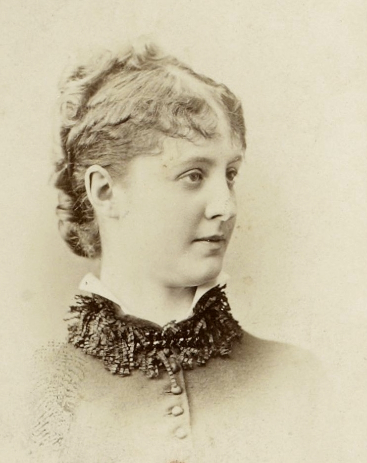 Sepia photographic portrait of a woman with her hair tied back