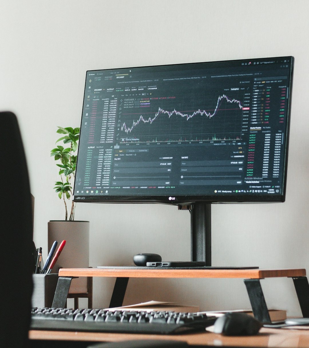 a computer monitor sitting on top of a wooden desk