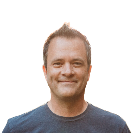 Portrait of a middle-aged man smiling in a dark crew neck t-shirt.