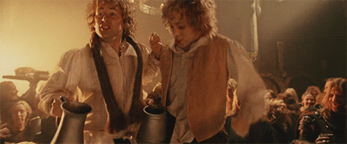 Merry and Pippin dance on the table holding giant tankards