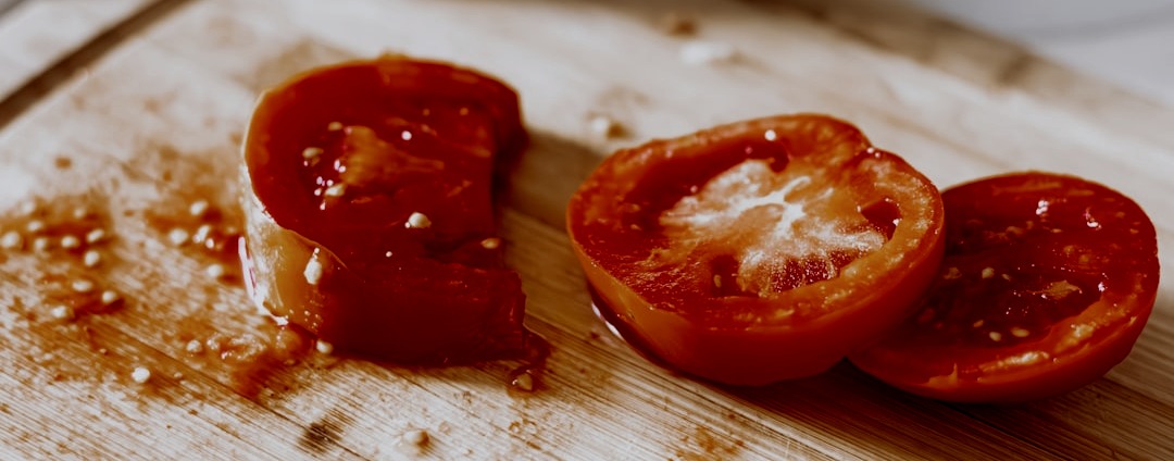 a wooden cutting board topped with sliced tomatoes