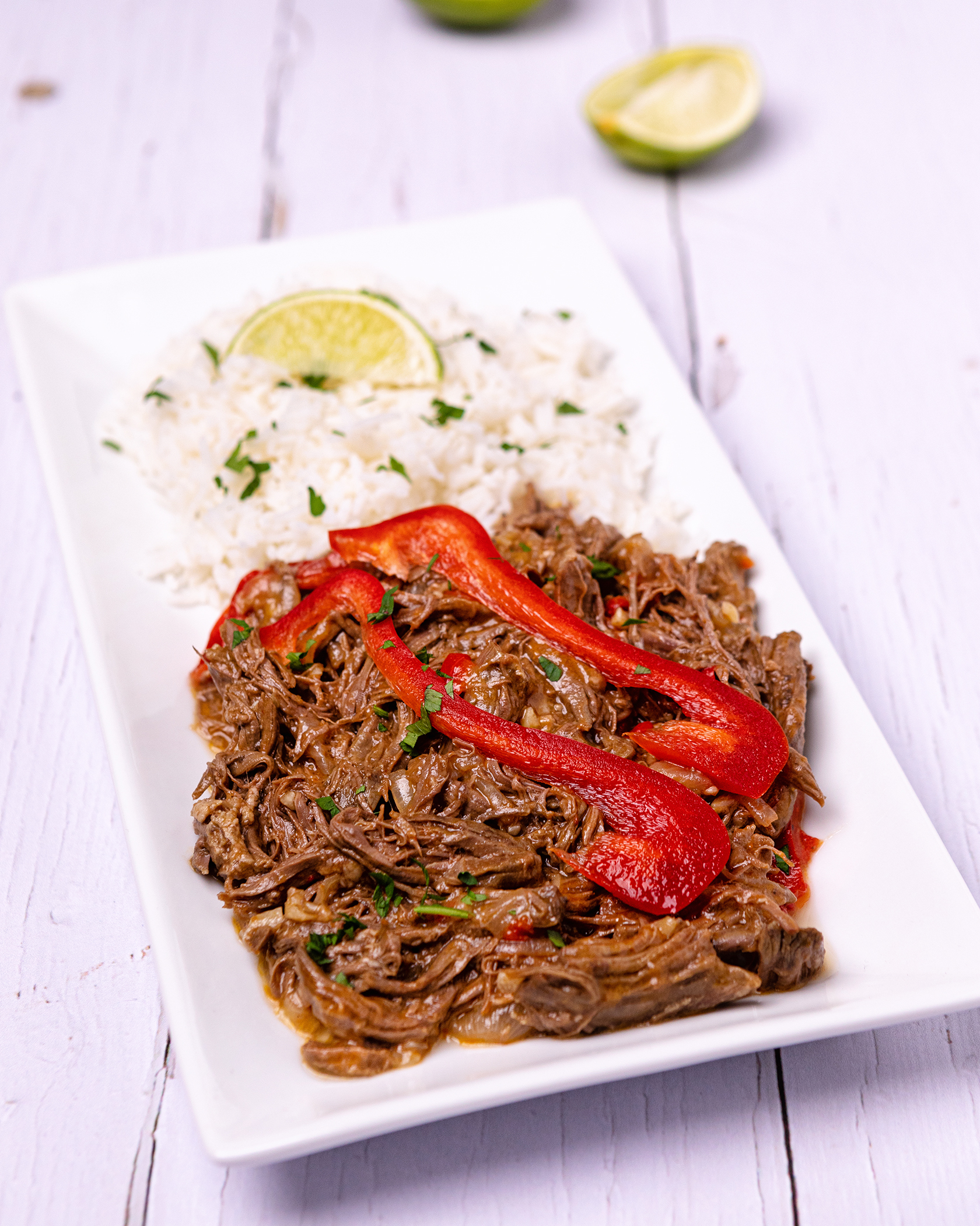 Ropa Vieja served on a white plate. Ropa Vieja served on a white plate.