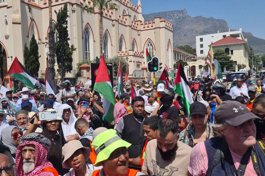 A diverse crowd of protesters in hats and scarves with palestine flags A diverse crowd of protesters in hats and scarves with palestine flags