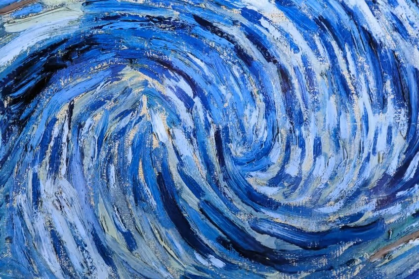 Close-up of thick blue and white swirling brushstrokes in The Starry Night