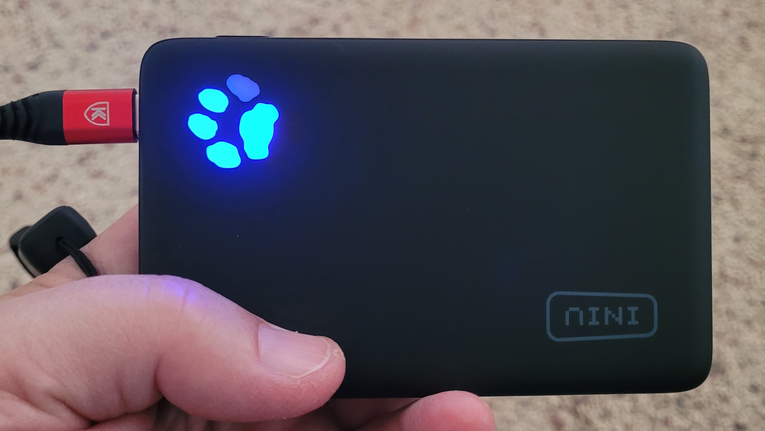 Iniu-brand power bank with LED power level shown as a paw