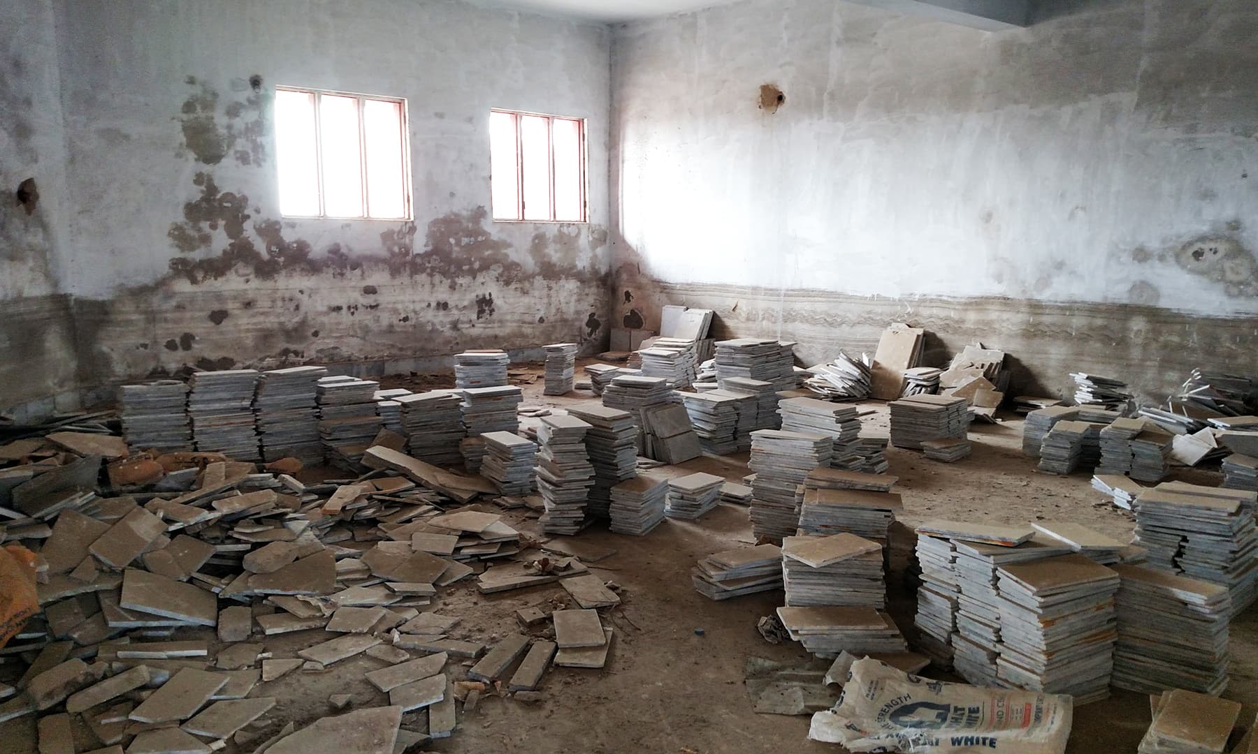 Construction material dumped in a classroom.. — Bilal Karim Mughal