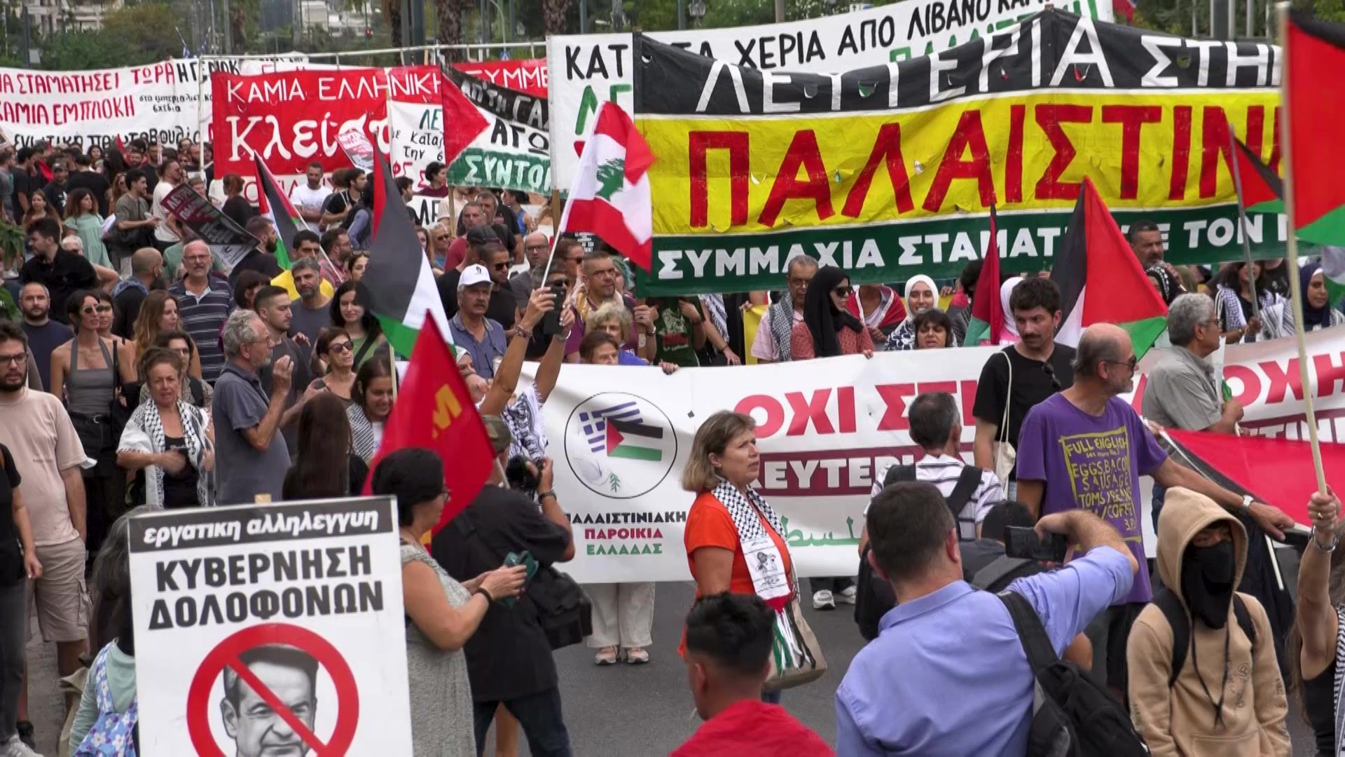 A diverse crowd waving Palestine and Lebanon flags with signs in cyrillic. A diverse crowd waving Palestine and Lebanon flags with signs in cyrillic.