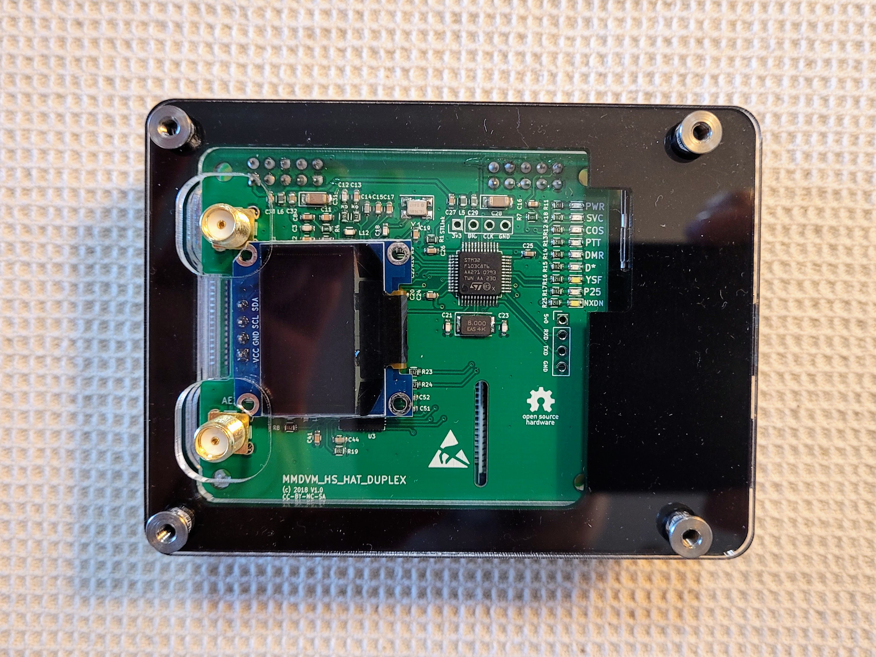 The top layer is clear and has holes for the antennas