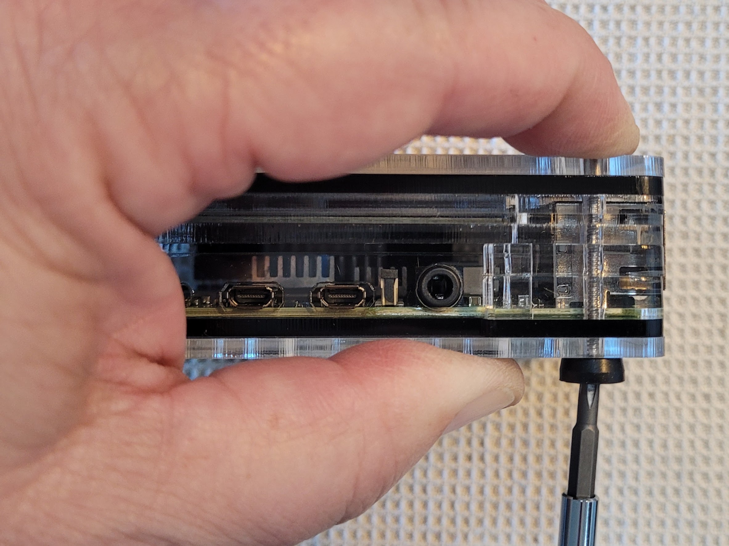 Using my finger to hold the nut while I tighten the screw