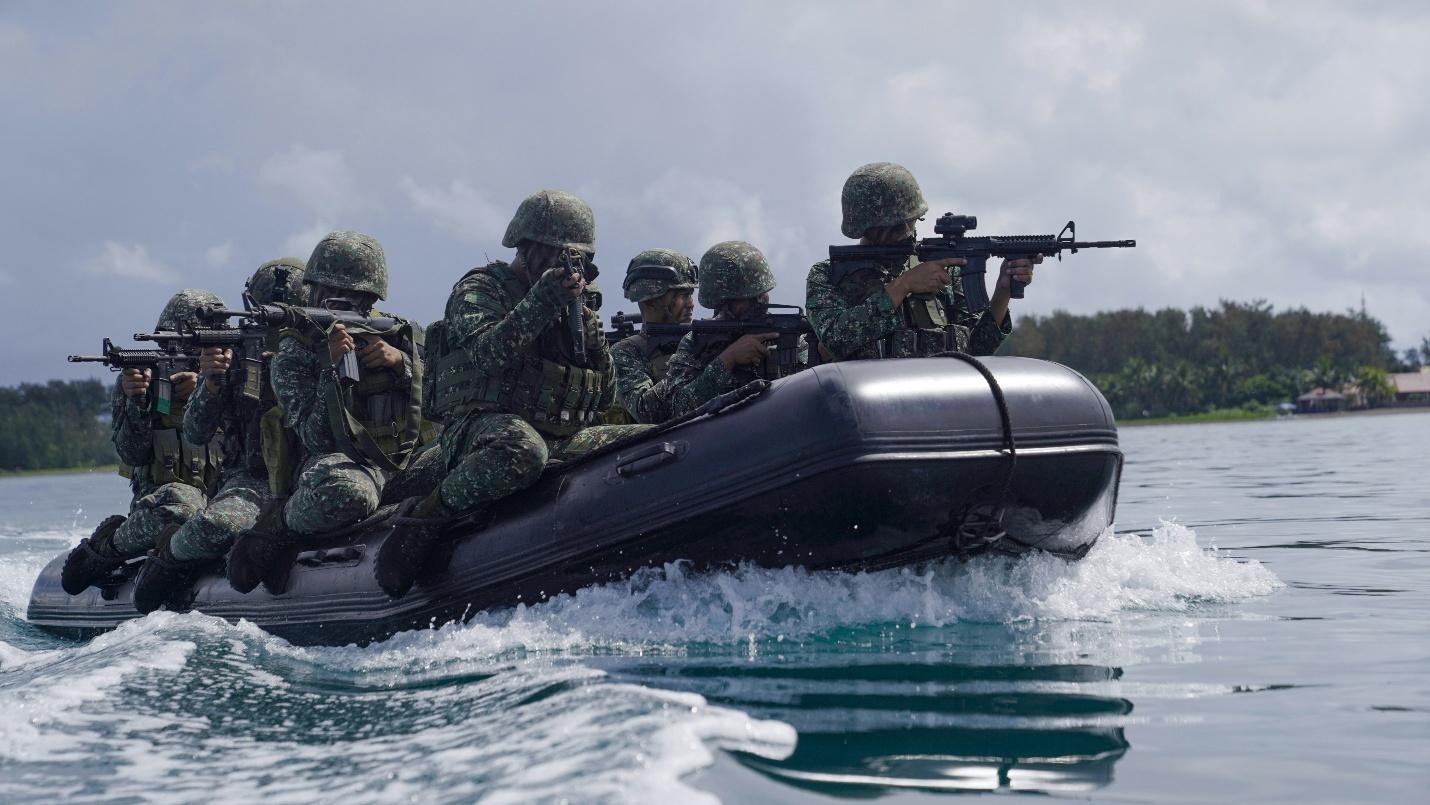 A group of soldiers in a boat with guns
AI-generated content may be incorrect.
