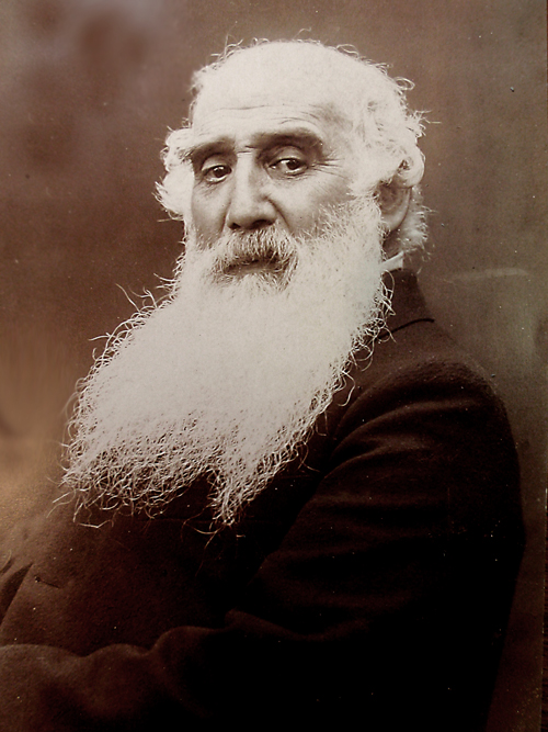 Historic photographic portrait of Camille Pissarro with a long white beard
