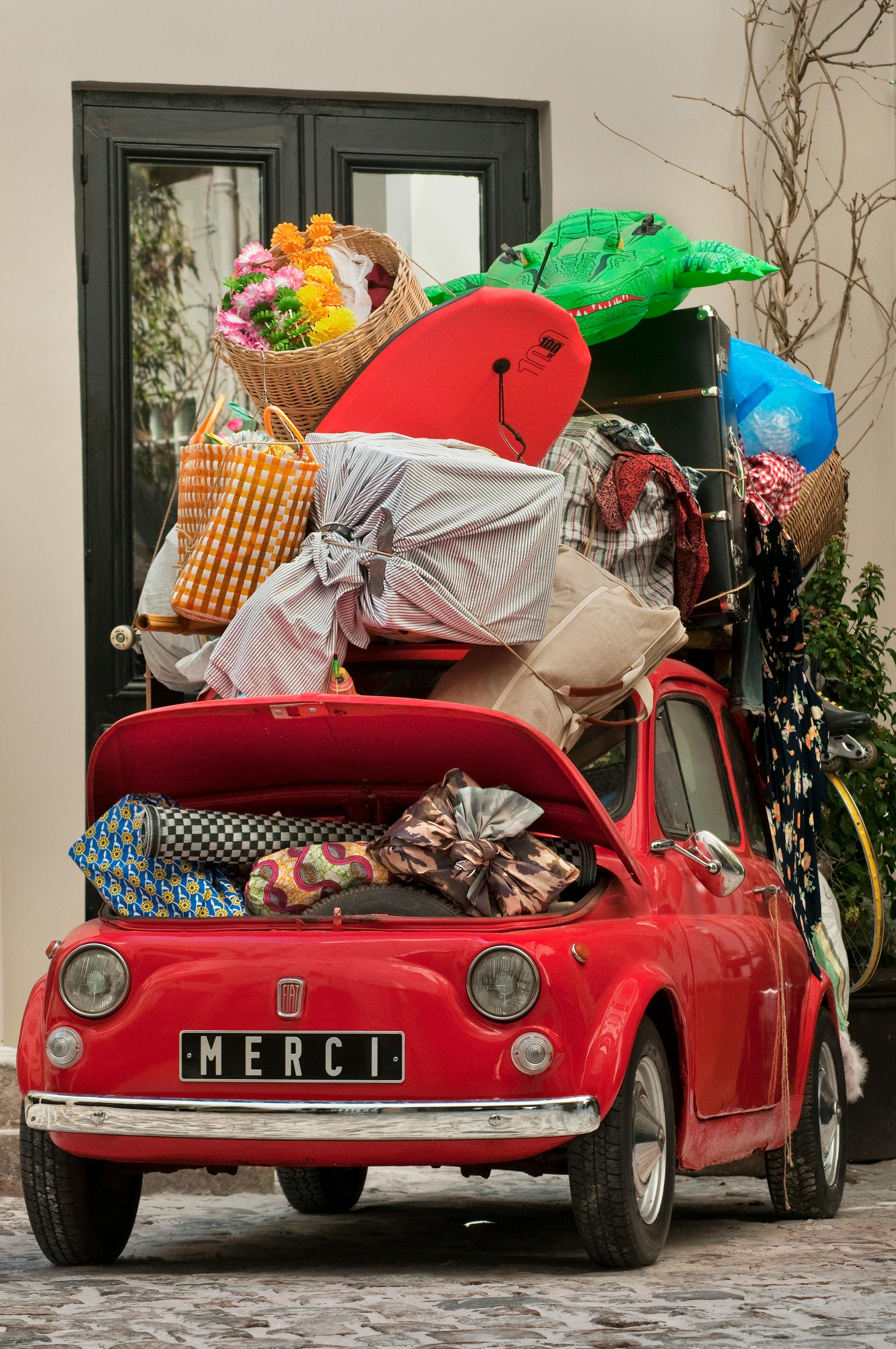 A small car, overloaded with luggage
