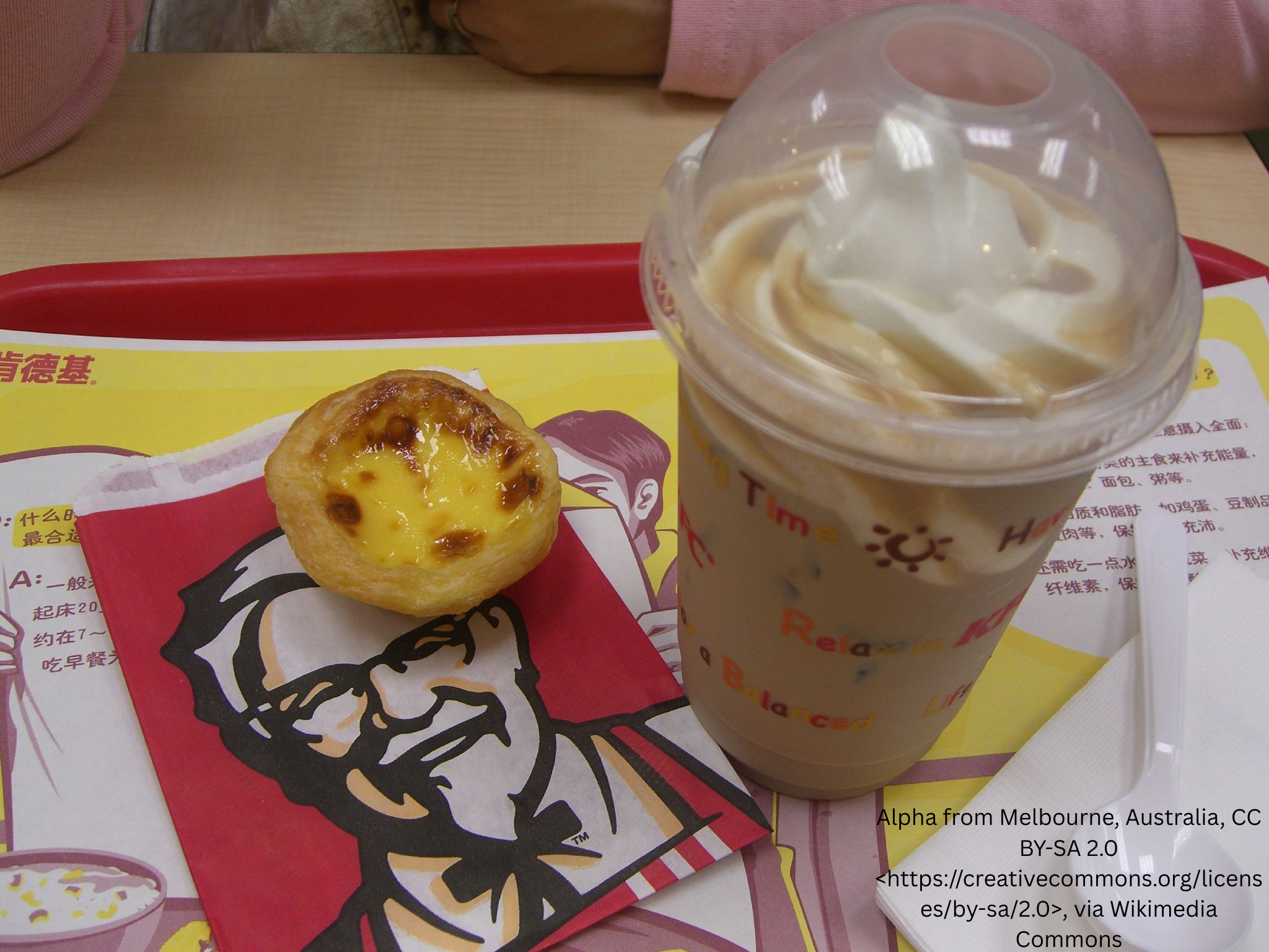 Custard tart served with a cold drink at a fast-food restaurant