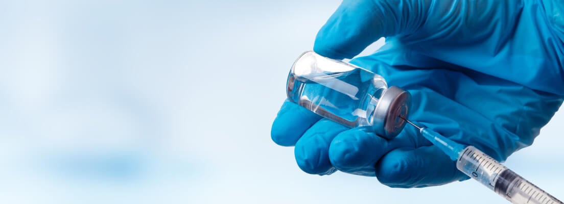 Hand in glove holding vaccine Hand in glove holding vaccine