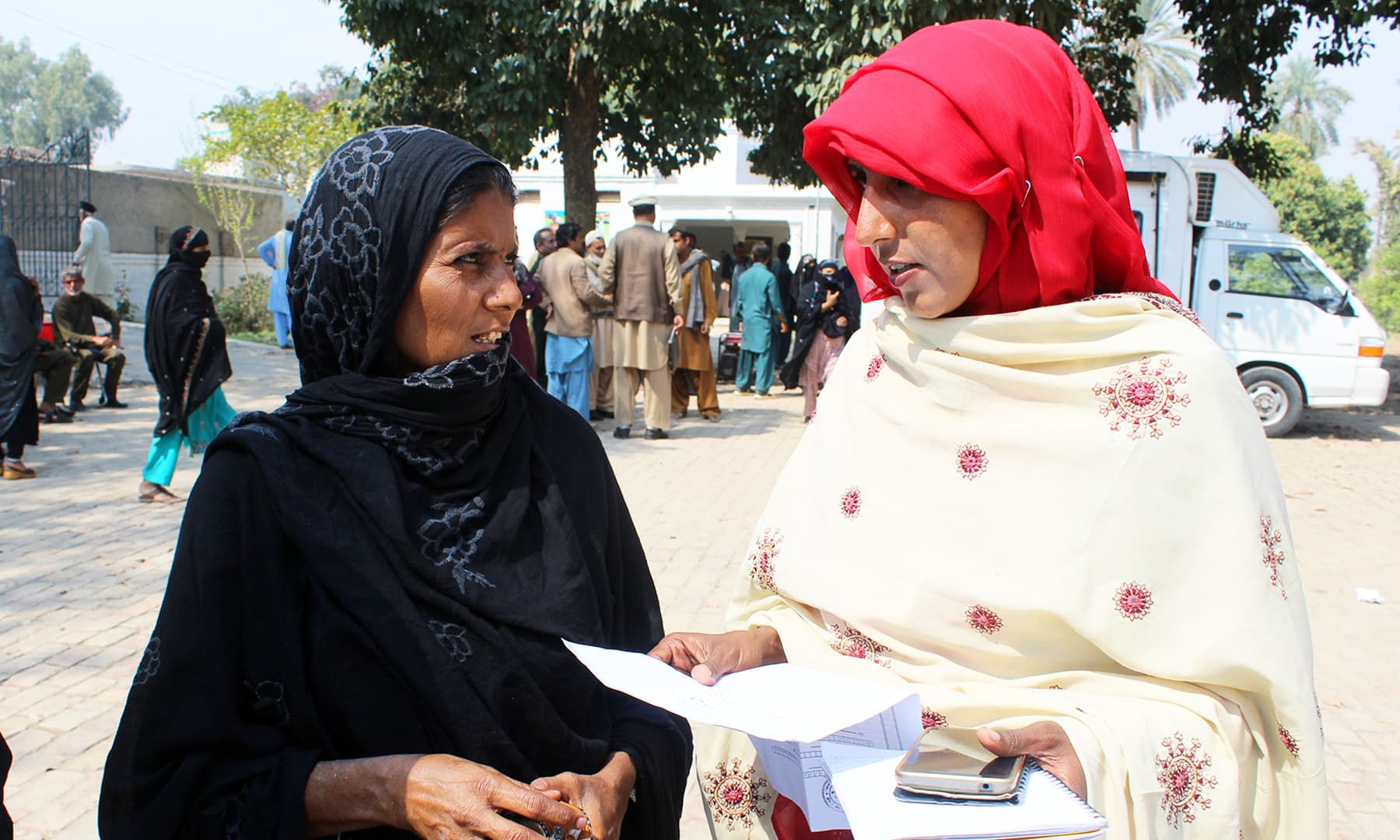 Social activist, Arshia, guides a woman about the process of obtaining a CNIC. — Photo by author