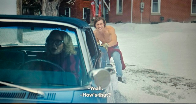 Jack pushing from behind the woman’s car, asking “How’s that?” while she replies “yeah.” 