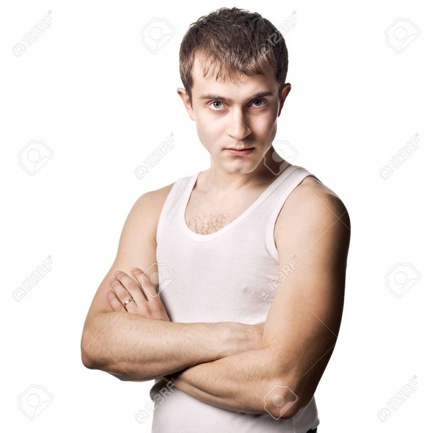 A young man with his arms crossed posing for the camera