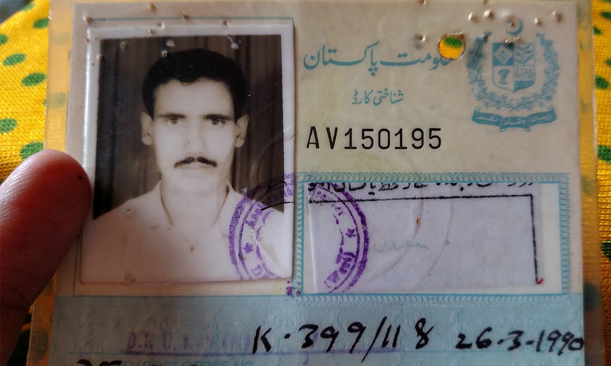 Ghulam Hussain shows his father's old National Identity Card | Bilal Karim Mughal