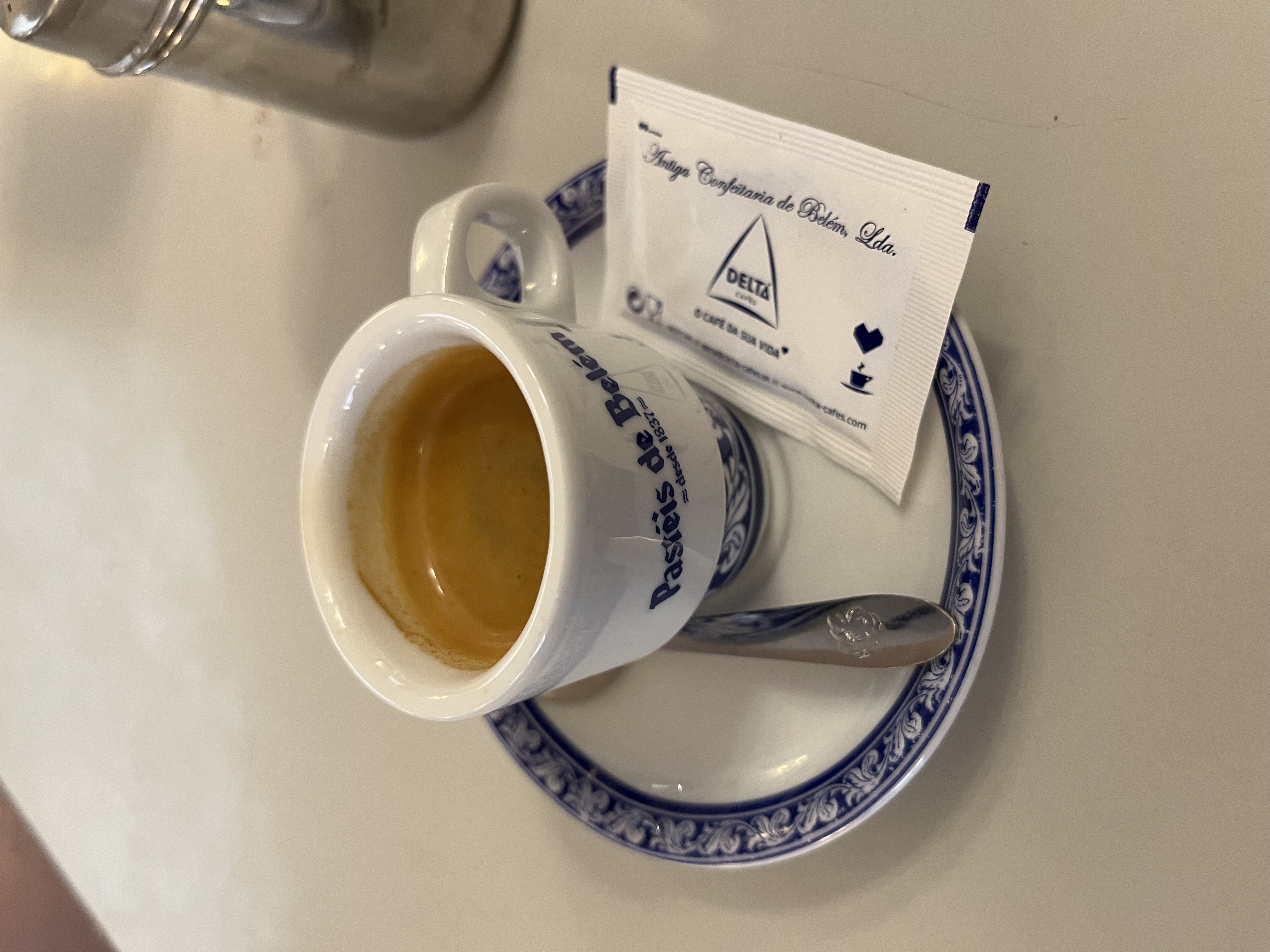 Espresso in a Pasteis de Belem cup on a blue-and-white saucer
