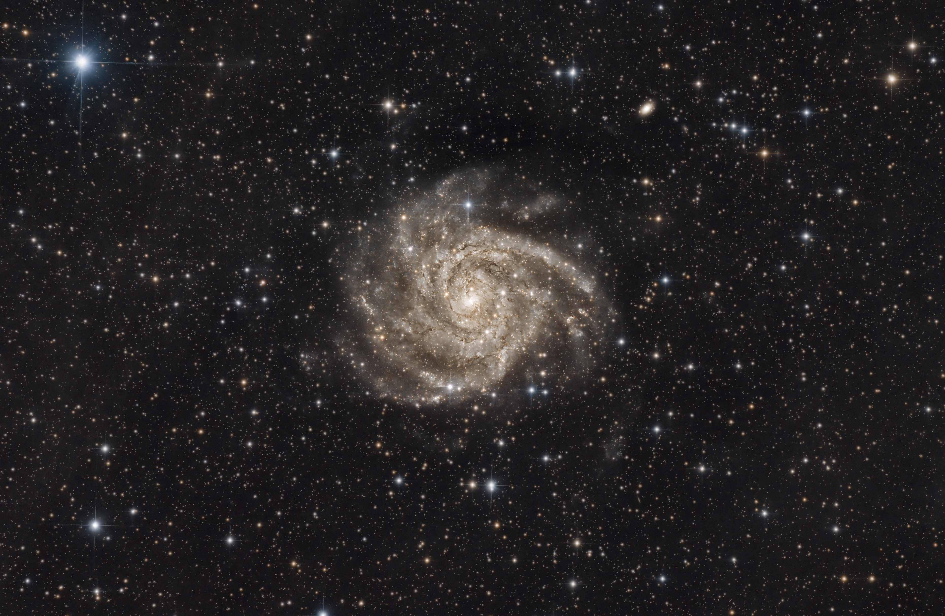 Spiral galaxy surrounded by stars in a dark sky