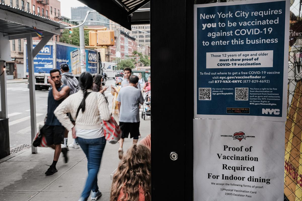 A sign in a restaurant window informs customers that they will need to show proof of vaccination for COVID-19 to be allowed entry, in New York City on Aug. 20, 2021. (Spencer Platt/Getty Images) A sign in a restaurant window informs customers that they will need to show proof of vaccination for COVID-19 to be allowed entry, in New York City on Aug. 20, 2021. (Spencer Platt/Getty Images)