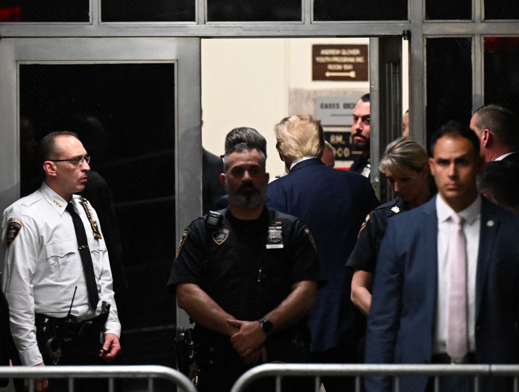 Trump leaving his hearing after getting charged.