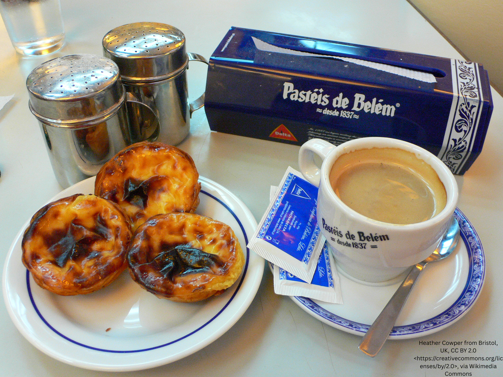Three pastel de nata tarts with coffee at Pasteis de Belem