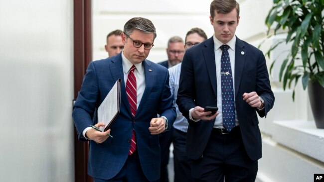 House Speaker Mike Johnson, left, arrives for a closed-door meeting with fellow Republicans at the Capitol in Washington, April 15, 2024.