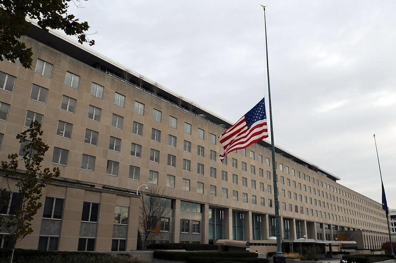 A flag flying in front of a building
AI-generated content may be incorrect.