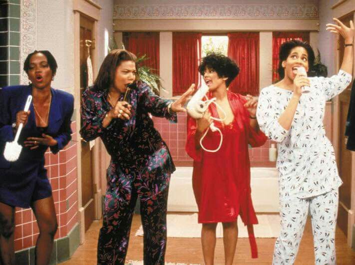 This may contain: three women in pajamas are singing into microphones while another woman is holding a video game controller This may contain: three women in pajamas are singing into microphones while another woman is holding a video game controller