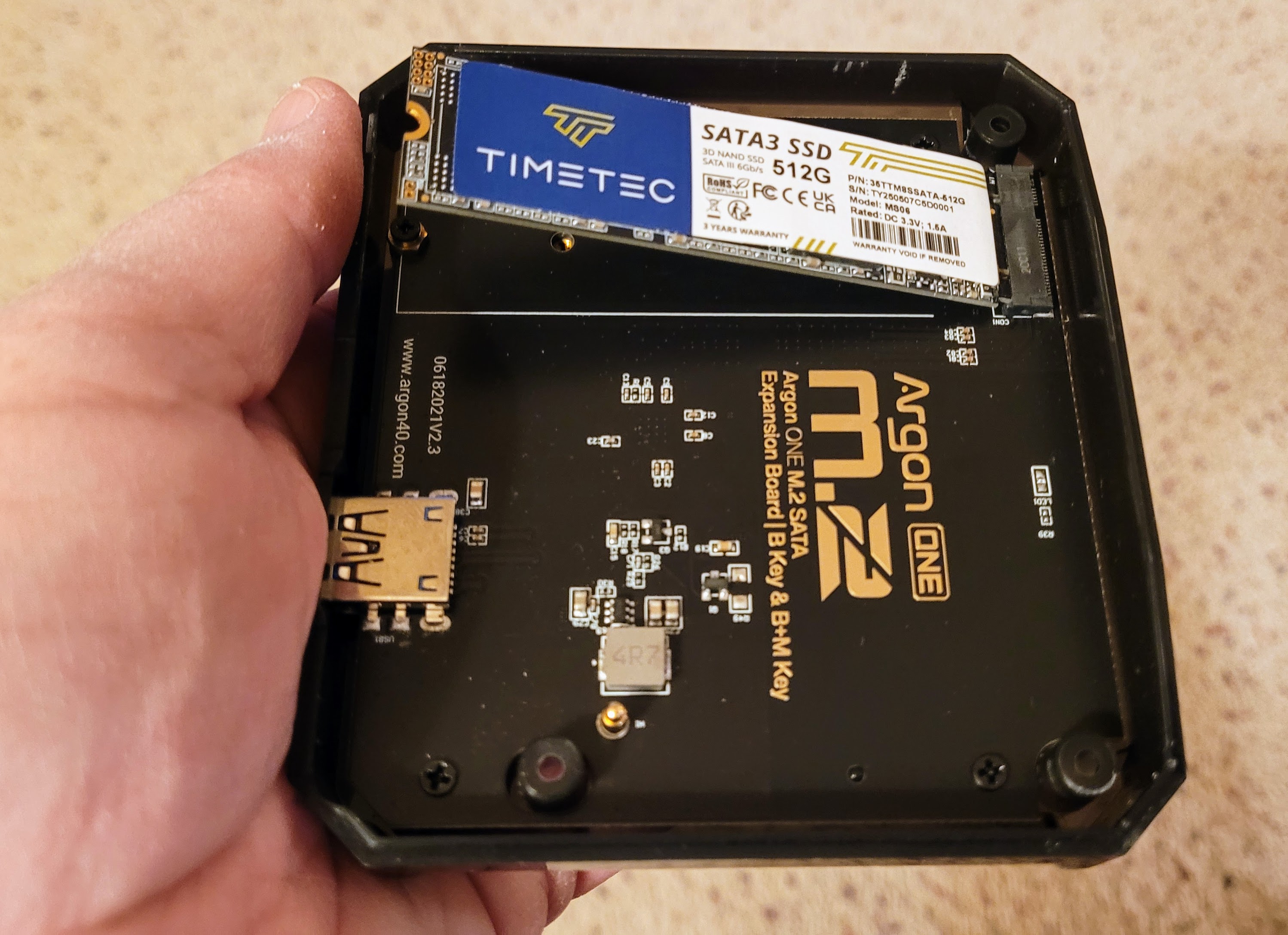 Slide the SSD board into the port at an angle
