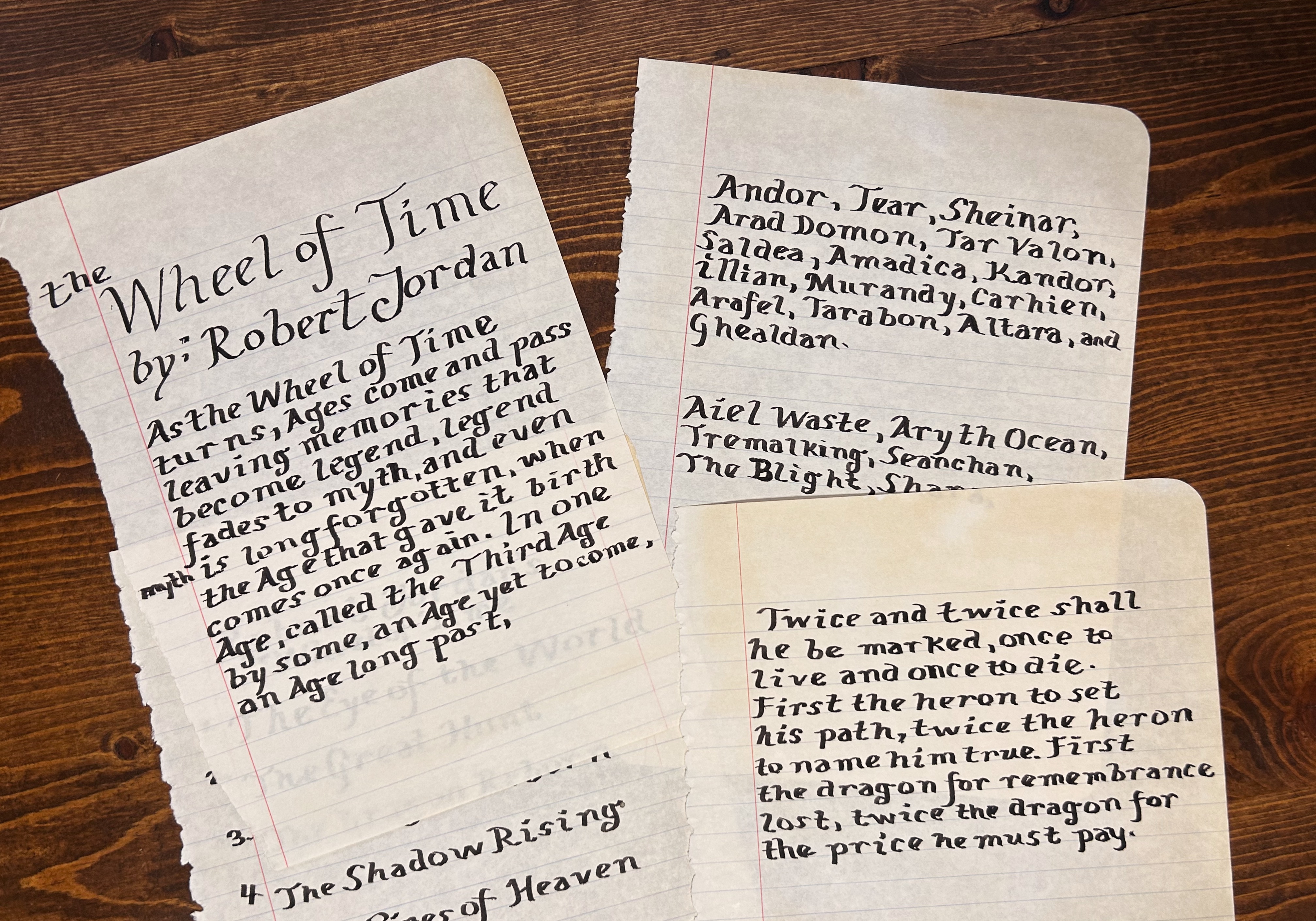 Italic calligraphy of the twice and twice prophecy, legend fades to myth quote, and lists of countries and WoT books. Pages yellowed and torn out of composition notebook.