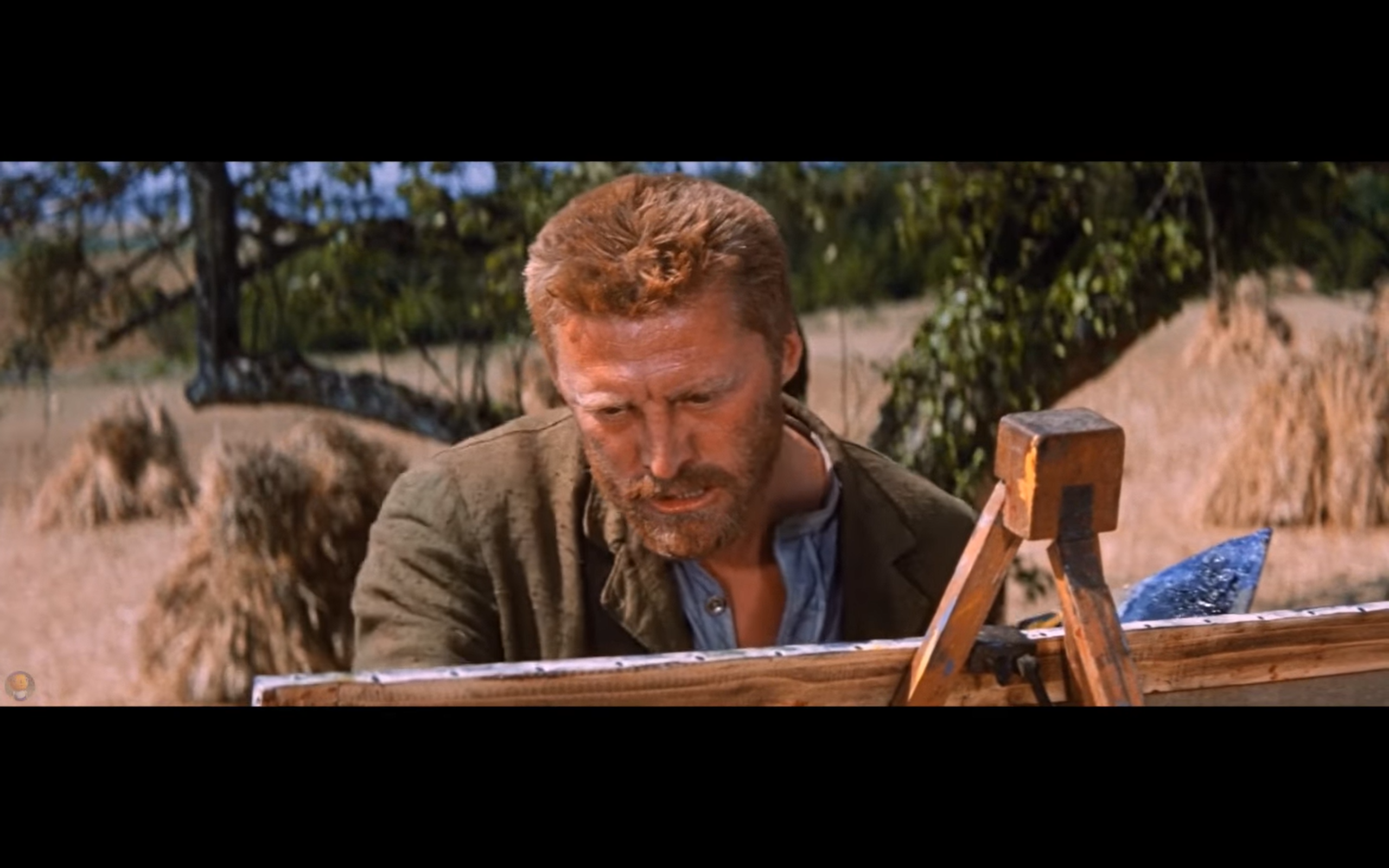 Kirk Douglas portraying Van Gogh painting at an outdoor easel in Lust for Life