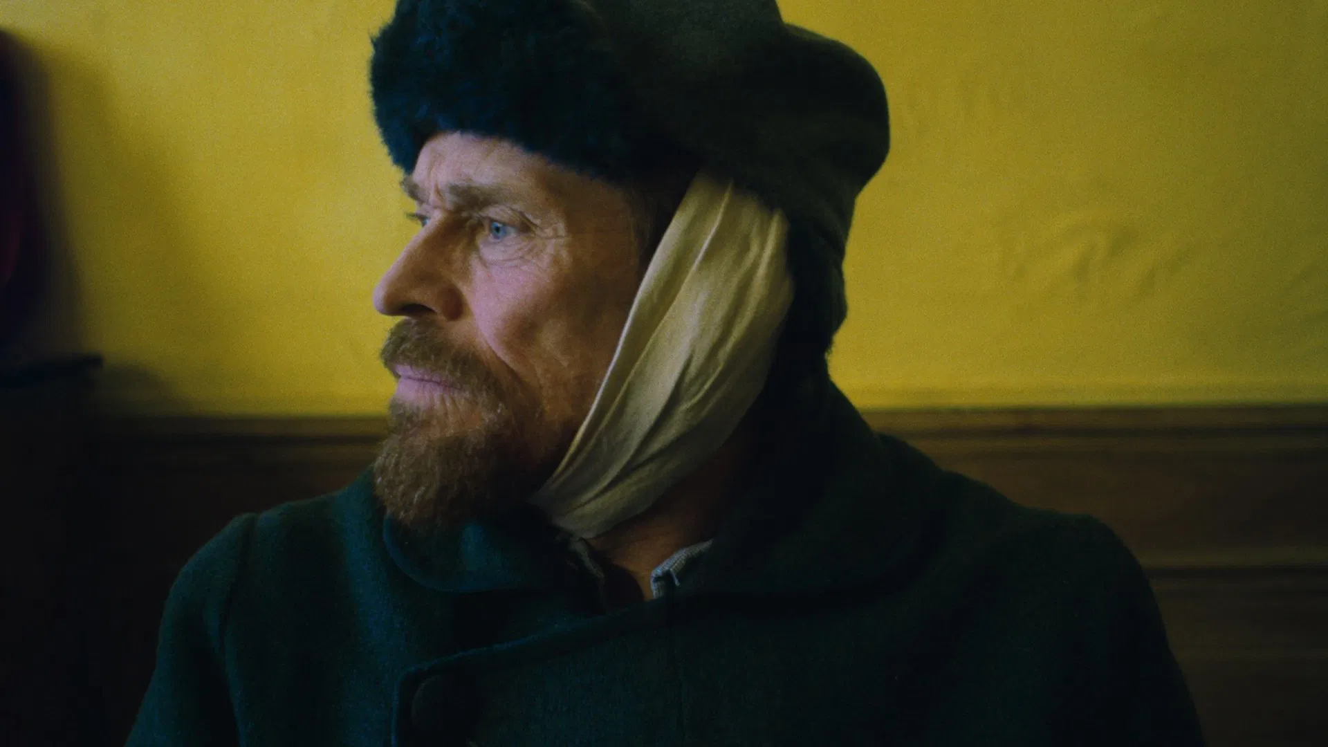 Willem Dafoe portraying Van Gogh with a bandage around his ear in At Eternity’s Gate