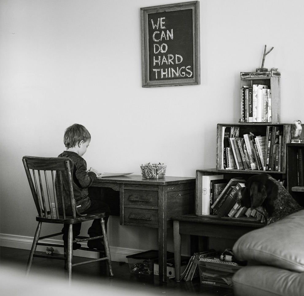 man and woman sitting on chair in front of table