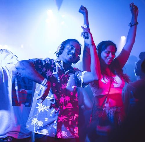 Vibrant nightclub scene with people dancing energetically to music