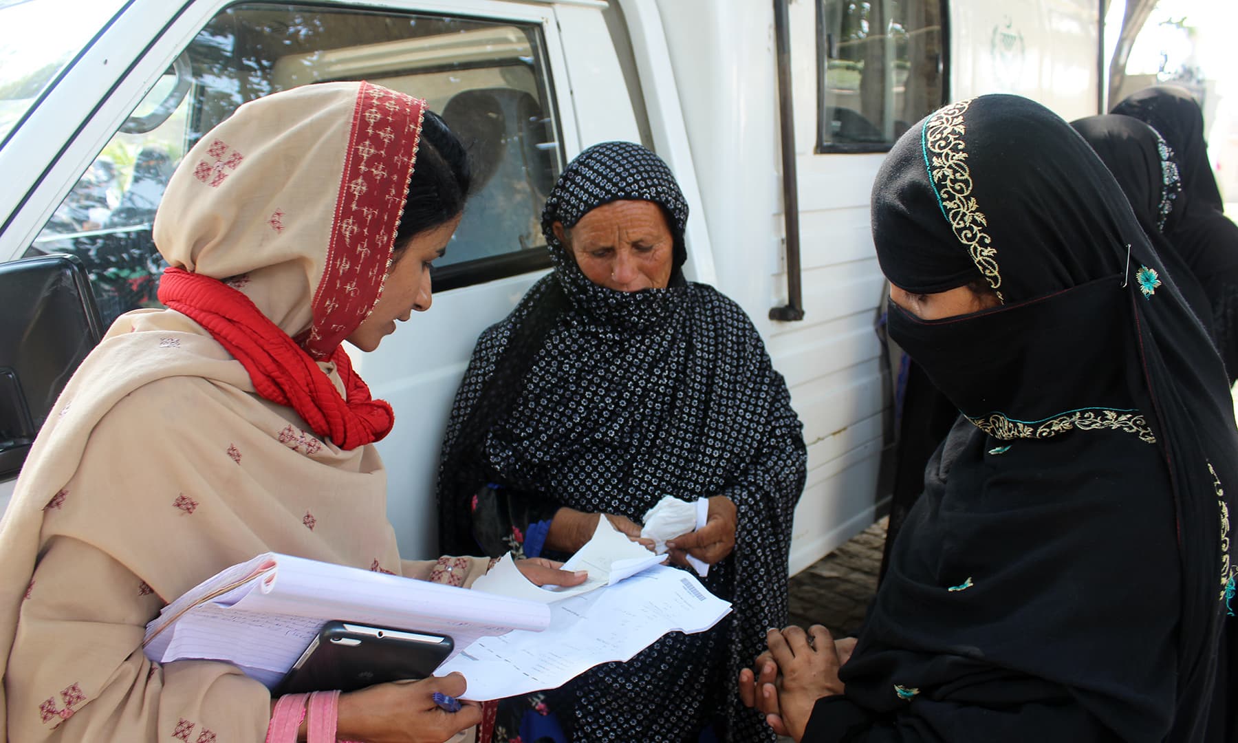 A social activist guiding women on how to get a CNIC made. — Photo by author
