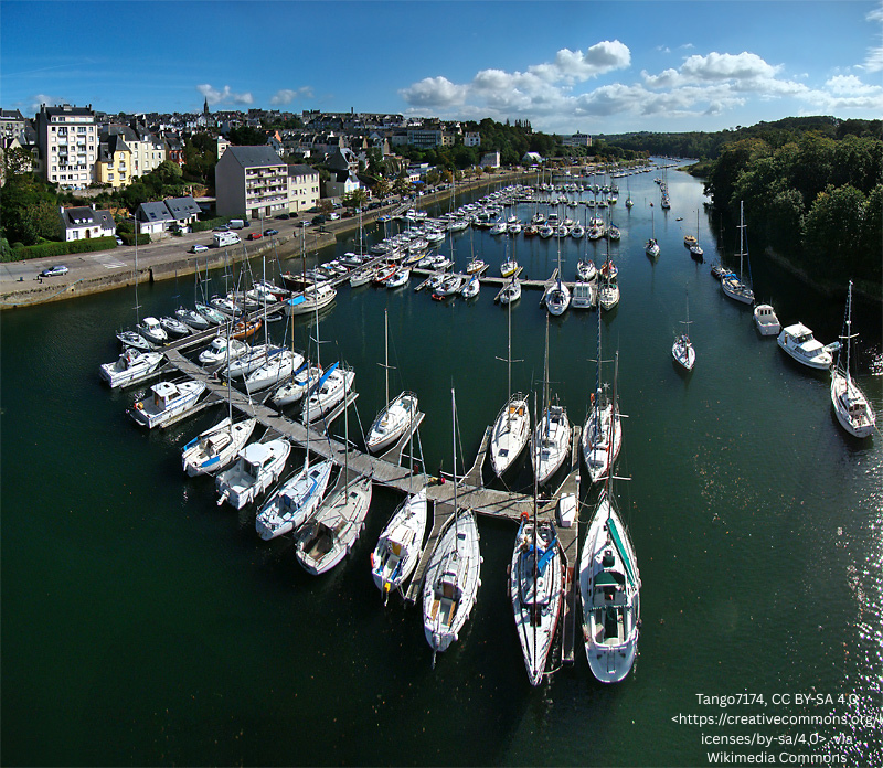 Harbor with sailboats moored beside a town in Brittany